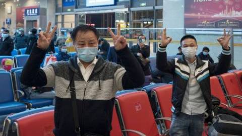 Passengers cheer up for Wuhan while waiting to take train K81 at Wuchang Railway Station in Wuhan, central China's Hubei Province, late April 7, 2020.