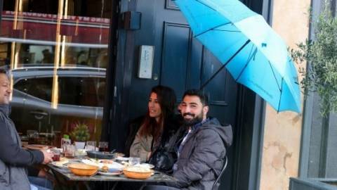 The new symbol of global optimism: Dining in the rain 