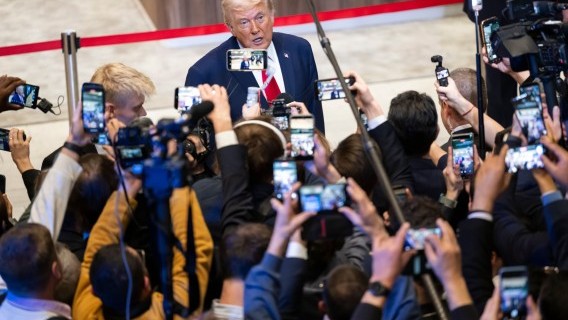 US President Donald Trump speaks with journalists after delivering his speech at the World Economic Forum in Davos