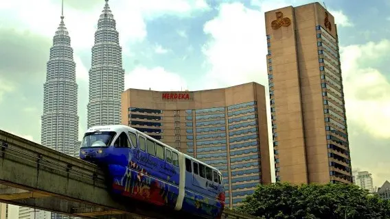 A train moves past skyscraper buildings in Kuala Lumpur Malaysia
