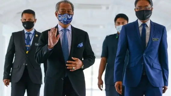 Malaysia's Prime Minister Muhyiddin Yassin (2-L) arriving for a meeting at parliament building in Kuala Lumpur, Malaysia