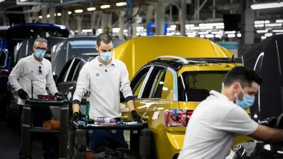 Workers wear protective masks at a Volkswagen factor in Portugal