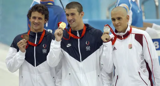 Michael Phelps shows off Oympic Gold in 2008