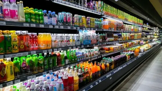 Variety of energy drinks, soda, soft drinks, fruit juice, non-carbonated, in bottles and cans in a supermarket