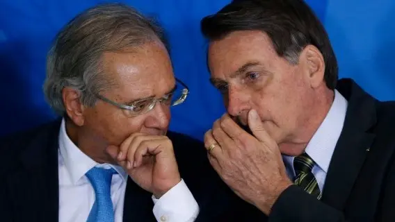 Brazil's President Jair Bolsonaro, right, talks with his Economy Minister Paulo Guedes