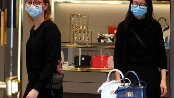 Some shop assistants in Milan are wearing protective face masks