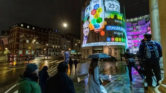 The results of an exit poll following the UK general election are projected onto Broadcasting House in London