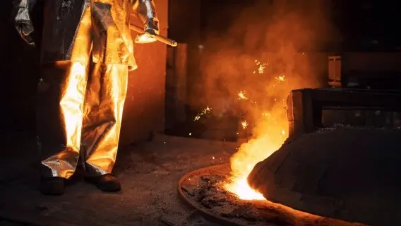 A worker oversees the iron smelting process