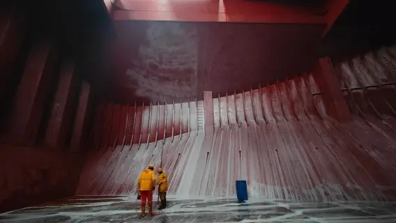 Staff cleaning the cargo hold in a bulk carrier