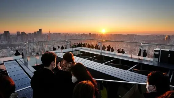 Sunrise on New Year's Day at an observation deck of a high-rise building in Tokyo