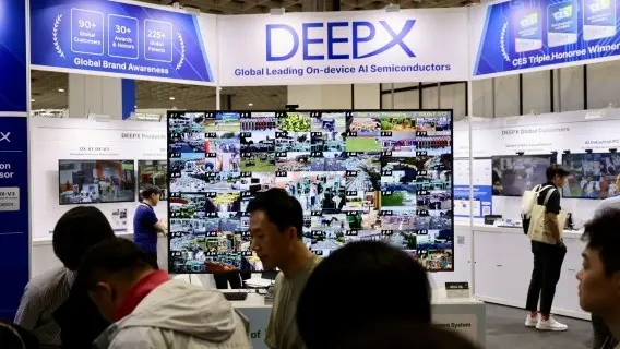 Visitors observing AI-assisted surveillance cameras during the Secutech 2024 exhibition show in Taipei, Taiwan