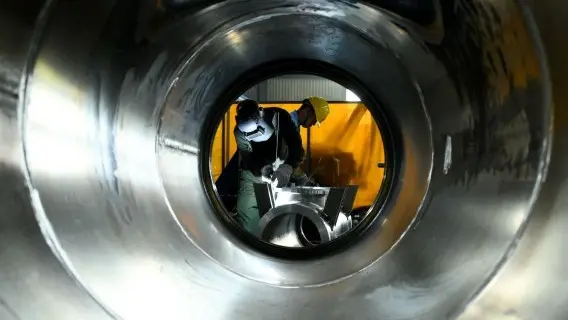 A Chinese factory worker producing aluminium housings used in power networks