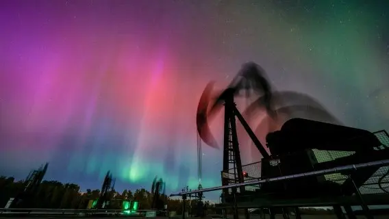 The Northern Lights make an appearance over pumpjacks as they draw out oil and gas from well heads in Canada