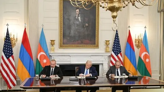 Azerbaijani President Ilham Aliyev, left, and Armenia's Nikol Pashinyan sign peace agreement in front of US President Donald Trump