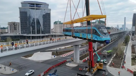 A train is lifted onto rails in Astana, Kazakhstan. Can its economy also stay on track?