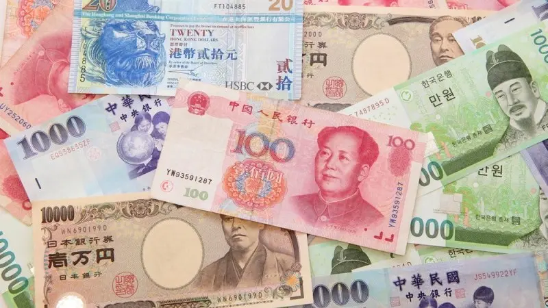 Asian currencies battered
